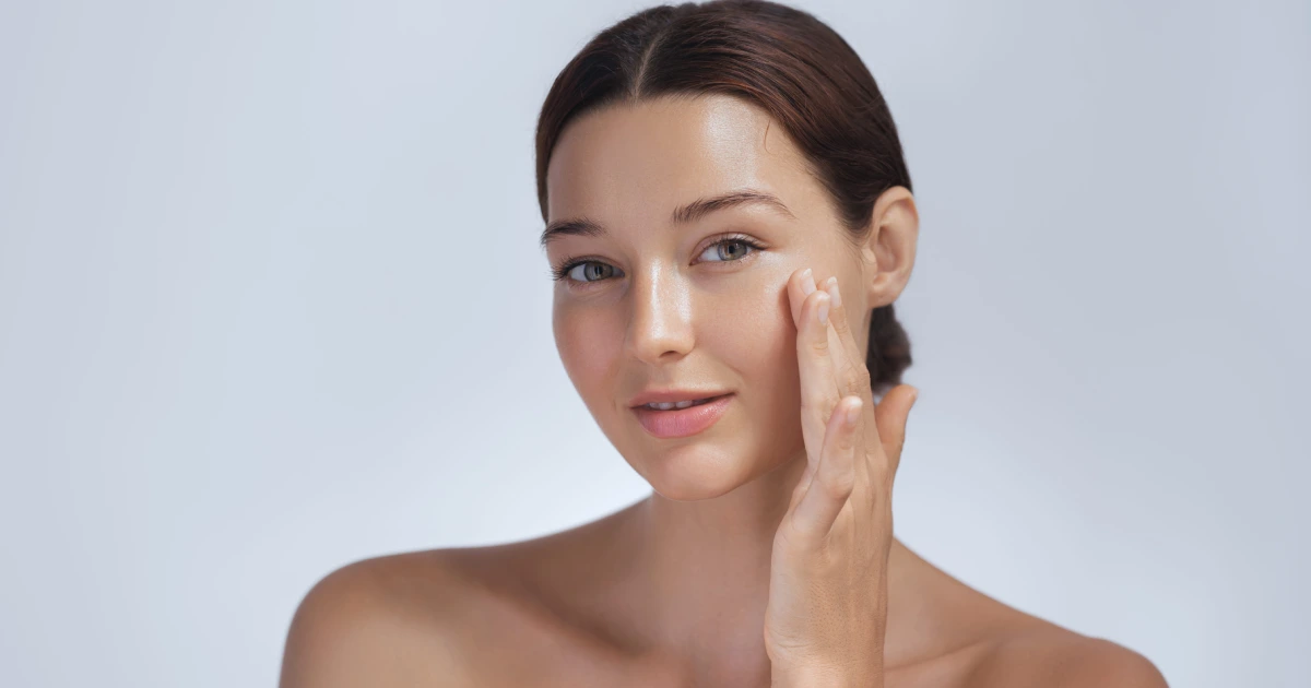 Woman showing smooth, glowing skin after a dermaplaning treatment in Cornelius, NC