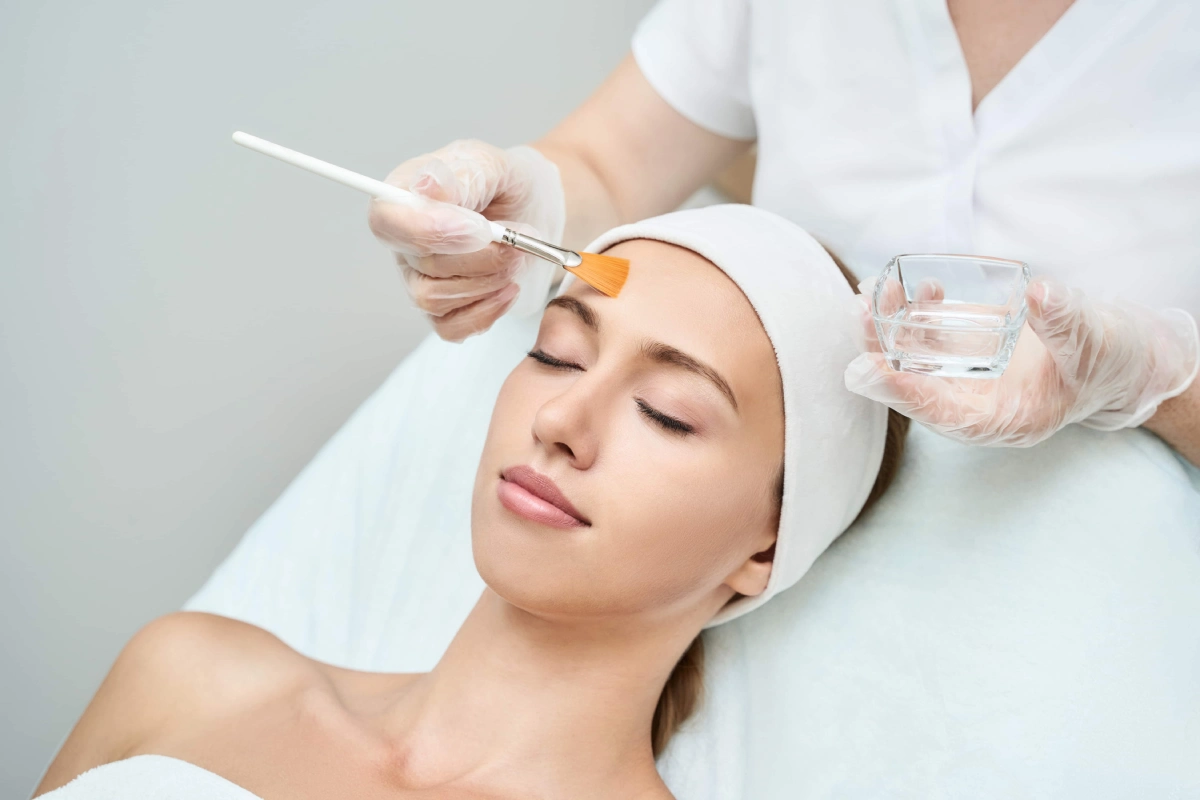 Patient receiving a facial peel treatment for sun damage correction in Fort Mill, SC.